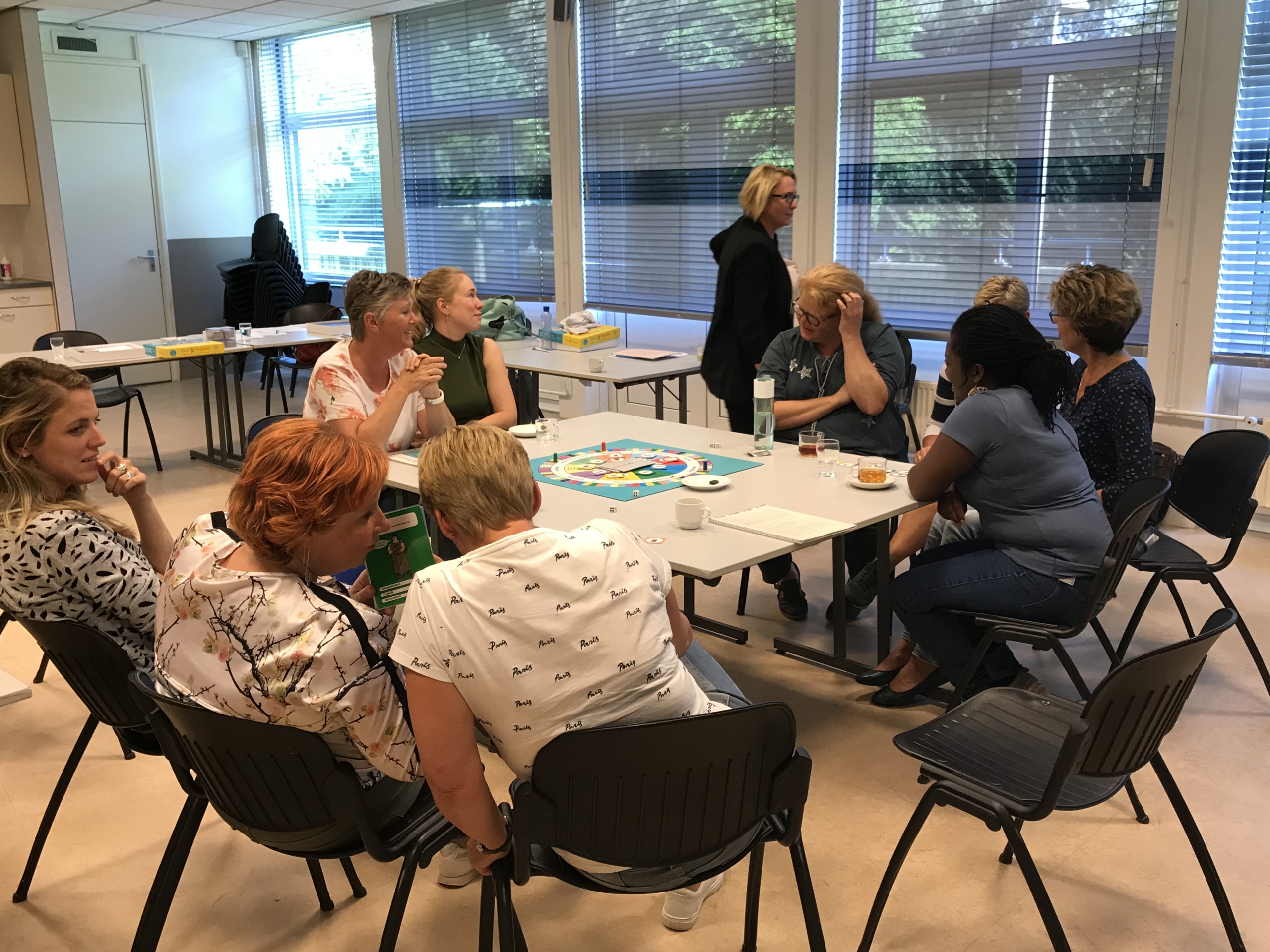 Een team van professionals speelt het Team Toppers bordspel tijdens een training